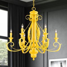 a yellow chandelier hanging from the ceiling