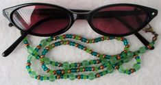 You'll always keep your reading glasses nearby using this green & brown beaded eyeglass chain! 25" in length, made with glass beads, beading cord, metal lobster clasps, and adjustable rubber holders. Lobster clasps make it easy to change the rubber holders, and an extra pair of holders included with every purchase. This green & brown beaded eyeglass chain will arrive in a gift box, ready to give as a present or to keep and store. Back to Beaded Eyeglass Chains Green Plastic Round Bead Jewelry, Adjustable Single Strand Glass Beaded Necklaces, Adjustable Single Strand Glass Beaded Necklace, Adjustable Green Beaded Necklaces With Lobster Clasp, Adjustable Czech Glass Beaded Necklaces With Lobster Clasp, Adjustable Green Beaded Necklace With Lobster Clasp, Adjustable Beaded Plastic Jewelry, Adjustable Round Bead Glass Necklaces, Adjustable Green Czech Glass Beaded Necklaces