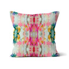 a colorful pillow with an abstract design on the front and back side, sitting on a white background