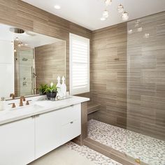 a bathroom with a sink, mirror and bathtub next to a shower stall in the corner