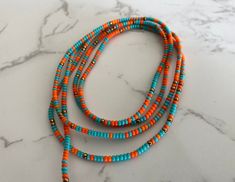 "The Obaa Sweetie handcrafted waist beads for all body types. These waist beads are designed to be tied on for long-term wear. Obaa means \"woman\" in the Akan language of Ghana, translating Obaa Sweetie to \"Sweet woman.\"   C O L O R  The color turquoise represents self-awareness. Orange symbolizes courage and vitality, and bronze exudes nature's aura and ideas of growth and strength.   M E A S U R E M E N T  0 - 55 Inches available. Know your measurement before ordering by measuring your wais Colorful Beads Lariat Necklace For Beach, Bohemian Adjustable Waist Beads With Spacer Beads, Adjustable Bohemian Waist Beads With Spacer Beads, Bohemian Heishi Beaded Waist Beads, Bohemian Beaded Chain Waist Beads, Adjustable Bohemian Waist Beads With Tiny Beads, Oval Tiny Beads Bracelets For Beach, Beach Beaded Bracelets With Tiny Oval Beads, Adjustable Waist Beads For Summer