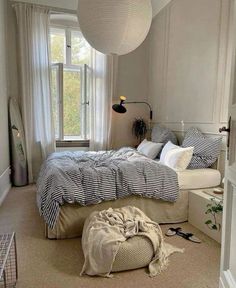 a bedroom with a large bed and white walls