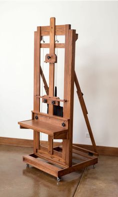 a wooden easel sitting on top of a hard wood floor