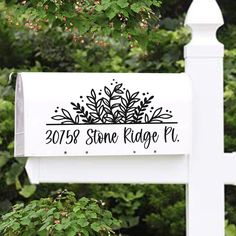 a white mailbox with the words stone ridge place on it and some bushes behind it