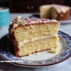 a slice of vanilla cake with sprinkles on a blue and white plate