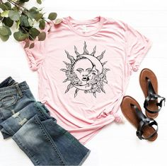 "Sun And Moon Face T-Shirt, Mystical Sun And Moon Shirt, Crescent Moon Tee, Celestial Shirt, Astrology Tarot Shirt Woman, Boho Sun Shirts ☀️☀️☀️☀️☀️ Everything in our shop is hand crafted and made to order. If you want different color or size contact me! If you would like something custom made to fit your personal style please message me and I will do everything to get you that something special. ---How To Order--- ⭐️Please, check and review all photos ⭐️Choose your t-shirt size and color ⭐️Enter your Design Color Example: \"White\" ⭐️Click add to cart. You can go back to add more product ⭐️Click \"Proceed to check out\" ⭐️When you check out, you can add a note to seller for any request *High quality and super soft, comfortable shirt. Made with top of the line vinyl and pressed with a prof Bohemian Short Sleeve T-shirt With Sun And Moon Design, Bohemian Cotton T-shirt With Sun And Moon Design, Spring Graphic Tee With Moon Print, Summer Moon Print Crew Neck Shirt, Summer Crew Neck Shirt With Moon Print, Casual Summer T-shirt With Sun And Moon Design, Spring Moon Print Cotton T-shirt, Spring Moon Print Relaxed T-shirt, Summer Moon Print Relaxed Fit Shirt