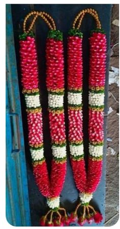 two red and white beads hanging from the side of a door