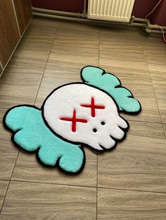 a blue and white rug with a cross on it in the middle of a floor