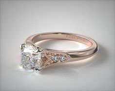 a white gold ring with an oval cut diamond and pave set diamonds on the sides