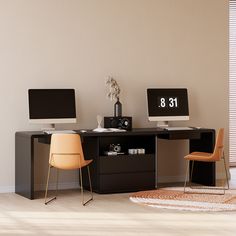 two computer monitors sitting on top of a desk next to each other in a room