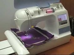 a white sewing machine sitting on top of a wooden table