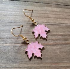 Lightweight 18k gold plated stainless steel light pink resin filled gold maple leaf earrings. Earrings are 1 inch long.  Be sure to check out more HANDMADE jewelry in my shop, DizzleBees, beautiful jewelry of all kinds available! Made with quality materials and always nickel and lead free metals ♡ Perfect gift for a friend or loved one: All jewelry pieces are packaged in silver silk jewelry pouches, wrapped carefully, and packaged with love. Beautiful wrapping for gift ready giving. Personalized gift messages available. See Gift Wrapping at checkout) STAY CONNECTED!! Follow and like my shop, DizzleBees! I am available all hours of the day to help with orders, answer questions, and anything else you need ♡ Message me on Etsy, I'll respond in minutes! New additions rolling in every day, and Pink Enamel Jewelry With Matching Earrings, Pink Enamel Dangle Jewelry, Hypoallergenic Pink Gold Earrings Gift, Hypoallergenic Leaf-shaped Jewelry Gift, Pink Enamel Earrings For Gift, Steel Light, Silk Jewelry, Jewelry Pouches, Silver Silk