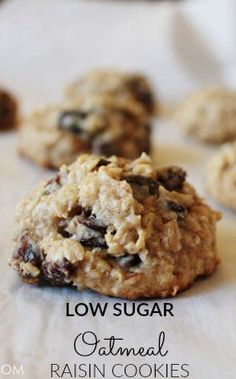 low sugar oatmeal raisin cookies on a white tablecloth with the words low sugar oatmeal raisin cookies