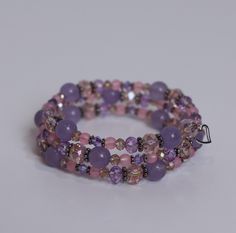 "Lavender Aura"- This piece is subtle and soft yet elegant. With pastel pinks and purples, this bracelet will add sparkle to your day. Lavender Aura comes packaged inside a hand crocheted, cat shaped pouch for safekeeping. This piece is ready to ship today! Lavender Bracelets With Spacer Beads As Gift, Lavender Bracelets With Spacer Beads For Gift, Lavender Beaded Crystal Bracelet As A Gift, Lavender Beaded Bracelets For Healing, Lavender Beaded Crystal Bracelet For Healing, Lavender Beaded Crystal Bracelet For Gifts, Adjustable Lavender Bracelets With Spacer Beads, Adjustable Lavender Bracelet With Faceted Beads, Adjustable Lavender Crystal Bracelet With Round Beads