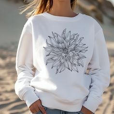 Celebrate your love for flowers with our Dahlia Sweatshirt, a cozy  long sleeve perfect for chilly days in the garden or out with the girls. SWEATSHIRT MATERIAL -50/50 Cotton polyester blend -Medim-heavy fabric -Loose fit -Runs true to size Care instructions: -Turn sweatshirt inside out -Machine wash in cold water -Dry on low temperature Shipping: Orders are processed and shipped within 1-7 days. Although our shipping is very timely, please allow 2 weeks especially around the holidays. Each orde Cotton Floral Print Long Sleeve Sweater, White Floral Print Sweatshirt For Fall, Spring Long Sleeve Top With Sunflower Print, Spring Long Sleeve Sunflower Print Top, Long Sleeve Sunflower Print Tops For Spring, White Floral Print Cotton Sweater, Spring Long Sleeve Botanical Sweatshirt, Botanical Long Sleeve Tops With Plant Print, Spring Plants Print Long Sleeve Sweatshirt