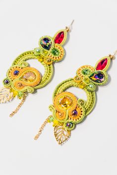 Elevate your style with the Aisha Earrings by Omela Jewelry. These exquisite soutache earrings are adorned with sparkling Swarovski crystals and backed with luxurious golden genuine leather. Measuring 9 cm in length and 3 cm at their widest point, they are lightweight yet make a bold statement. Perfect as a thoughtful gift for your wife, mom, or sister, these earrings add a touch of sophistication to any ensemble. Details: Length: 9 cm (3.5 inches) Width: 3 cm (1.1 inch) Materials: Swarovski crystals, golden leather, soutache thread genuine Lightweight design for comfortable wear Handmade with precision and care, the Aisha Earrings are a testament to fine craftsmanship and attention to detail. The intricate soutache design combined with the brilliance of Swarovski crystals creates a unique Earrings Colorful, Soutache Earrings, Party Earrings, Earrings Hoop, Colorful Earrings, Jewelry Earrings Hoops, Thoughtful Gifts, Unique Pieces, Ideal Gift