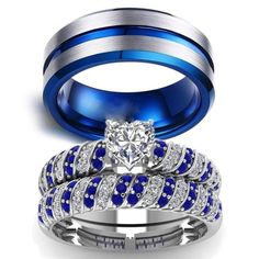 two wedding rings with blue and white diamonds on them, one has a heart shaped diamond in the center