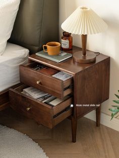 a night stand with two drawers and a lamp on the end table next to it