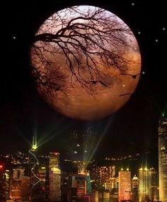 the full moon is shining brightly in the night sky over a cityscape with skyscrapers