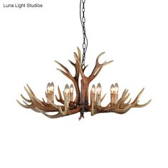 a chandelier with antlers hanging from it's center and five lights on each side