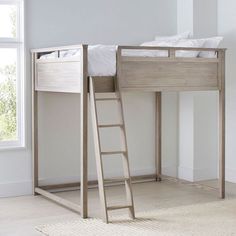 a bunk bed with a ladder next to it in a white walled room and a window