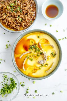 two bowls filled with food next to each other on top of a white countertop