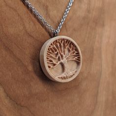 a wooden pendant with a tree on it