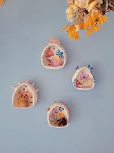 four small ceramic figurines sitting on top of a table