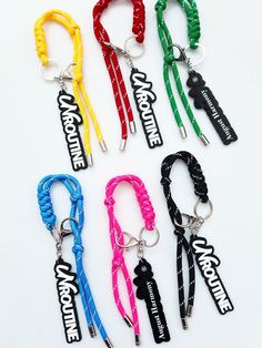 six lanyards with the words adventure written on them, all in different colors