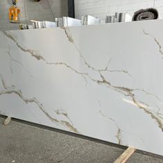 a white marble counter top sitting in a room next to a pile of other items