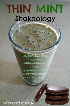 there is a chocolate shake and two cookies on the table next to it, which reads thin mint shakeology