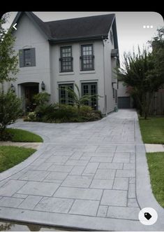 a large white house with a driveway leading to it