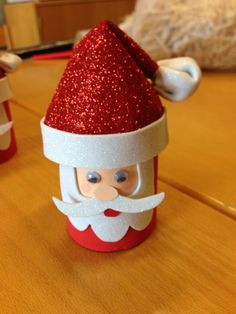 a santa clause cup sitting on top of a wooden table