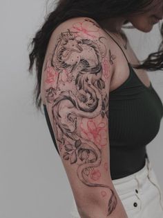 a woman with a dragon tattoo on her arm