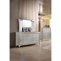 a white dresser and mirror in a room