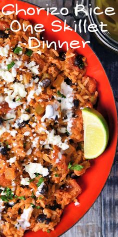 a red plate topped with rice covered in sauce and garnished with cilantro