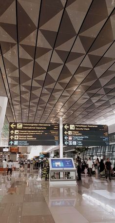 people are walking through an airport terminal