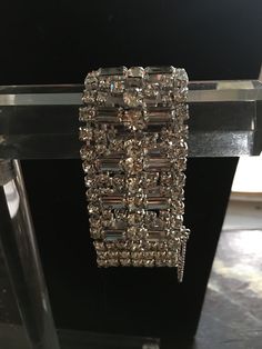 Kramer of New York wide rhinestone bracelet in clear stones and marked. Good condition and all sales final. Glamorous Evening Bracelet With Rhinestones, Glamorous Evening Bracelets With Rhinestones, Glamorous Evening Bling Bracelets, Glamorous Diamond Bracelet With Rhinestones, Diamond Tennis Bracelet For Parties, Evening Rhinestone Bracelet, Evening Rhinestone Bracelet Jewelry, Dazzling Evening Bracelets With Sparkling Stones, Glamorous Sparkling Evening Bracelets