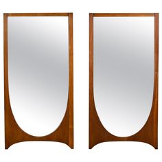 a pair of mirrors sitting next to each other on top of a wooden frame,