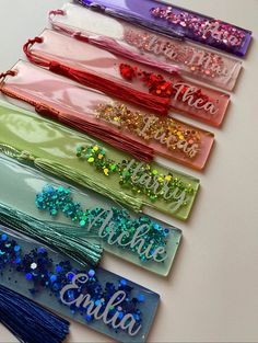 six personalized hair ties with glitter on them are lined up next to each other