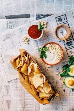 some food is laying out on top of the newspaper and it's contents are ready to be eaten