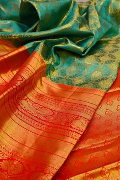 Do you think to buy the best and richness-filled kanjeevaram silk but with a twist element like the brocade? This turquoise green color kanjeevaram silk mark saree comes with brocade work and a broad border to make you party-ready any time. Color: A shade of turquoise green color Technique: This fabric comes with fantastic work of brocade and golden zari on the whole saree Fabric: Kanjeevaram Silk Quality: IndyVogue's Assurance of Silk Mark Certified Transitional Green Lehenga For Puja, Green Brocade Saree With Meenakari, Festive Turquoise Silk Traditional Wear, Ceremonial Green Paithani Silk Saree, Green Paithani Silk Lehenga With Self Design, Ceremonial Green Meenakari Lehenga, Ceremonial Green Lehenga With Meenakari, Turquoise Silk Saree With Pallu Detail, Ceremonial Green Tussar Silk Dupatta