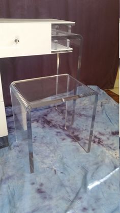 an acrylic desk with two drawers on it