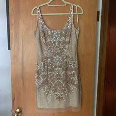 Stunning Nude Cocktail Dress. Many Embellishments. Worn Once - Noticed A Few Of Sequins On Side Have Come Off But Not Noticeable. Fully Lined And In Great Condition!! Make Me An Offer. Champagne Embellished Mini Dress For Formal Occasions, Champagne Embellished Mini Dress For Formal Events, Formal Embellished Champagne Mini Dress, Elegant Embellished Champagne Mini Dress, Elegant Champagne Embellished Mini Dress, Holiday Embellished Dressy Dresses, Festive Embellished Champagne Sequin Dress, Champagne Sleeveless Embellished Evening Dress, Holiday Champagne Embellished Sequin Dress