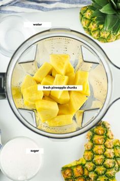 fresh pineapple chunks in a blender with ingredients labeled on the top and below