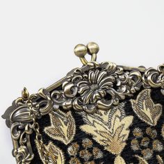 a black and gold purse sitting on top of a table