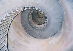 an overhead view of a spiral staircase with snow on the ground