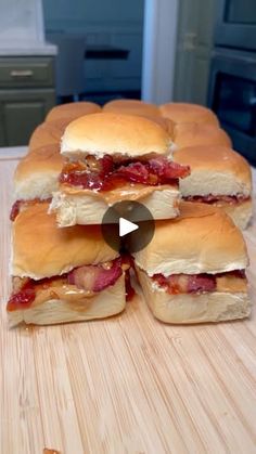 several sandwiches stacked on top of each other with meat and cheese in between them, sitting on a cutting board