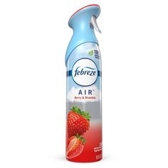 a bottle of air freshener sitting on top of a white surface with strawberries