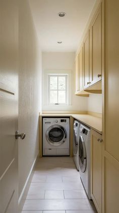 a washer and dryer in a small room with white tiles on the floor